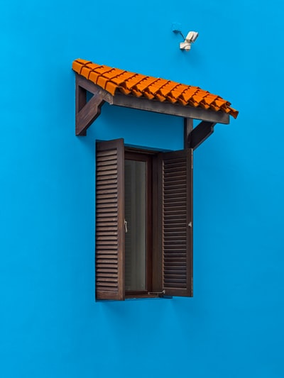 Blue brown wooden window frame on the wall
